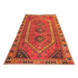 A hand woven wool village rug,