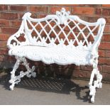 A Coalbrookdale style cast iron garden bench, with trellis back and foliate scroll frame,