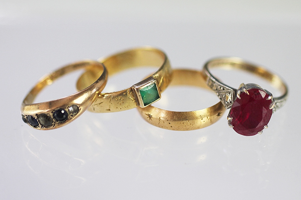 An 18ct yellow gold band weight 2.8gms, an 18ct yellow gold band with green stone inset, weight 3.