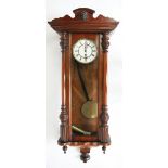 A walnut Vienna regulator wall clock, enamelled Roman numeral dial with subsidiary seconds,