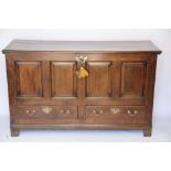 A George III oak mule chest, with hinged top above a four panelled front and two drawers,