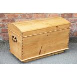 A pine blanket box, with domed top and fitted casters,