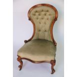 A Victorian carved walnut salon chair, with green drailon upholstery,