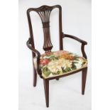 Two Edwardian carved mahogany dining chairs, with pieced splats and upholstered seats,