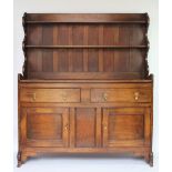 A 1920's oak dresser, with two drawers and two cupboard doors, on bracket feet,