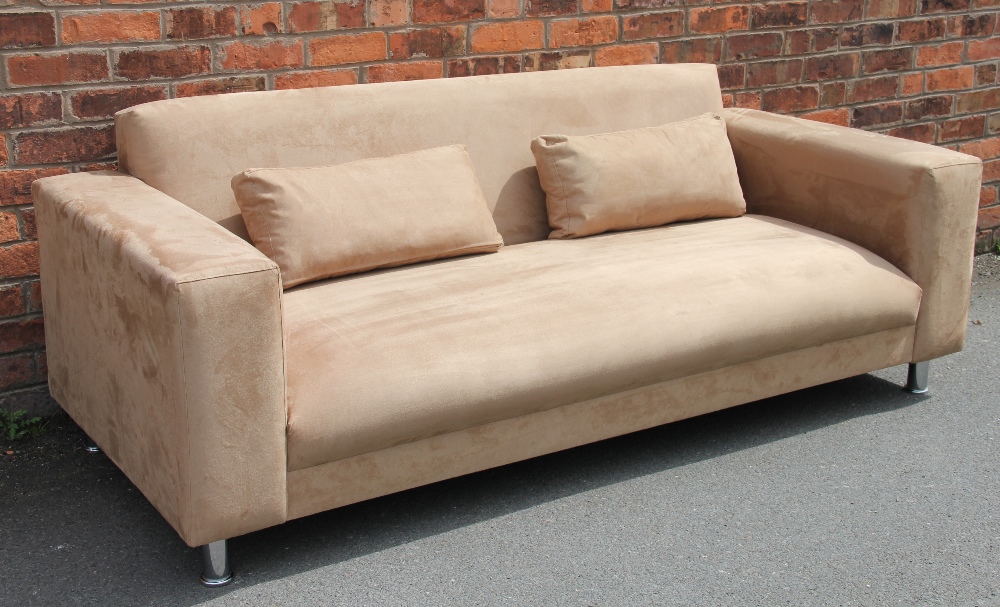 A modern tan suede three seater settee, possibly Italian, on turned white metal legs,