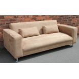 A modern tan suede three seater settee, possibly Italian, on turned white metal legs,