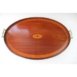 An Edwardian inlaid mahogany oval serving tray, with brass handles,