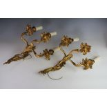 A pair of French Louis XV style gilt brass three branch wall lights,