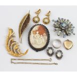 A collection of jewellery to include; a shell set bracelet, a carved shell cameo brooch,