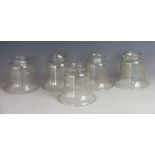 Five Edwardian clear glass light shades, three and two, with foliate detailing, 9cm,