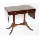 A reproduction cross-banded mahogany sofa table, with two drawers, on out swept reeded legs,