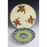 A Crown Ducal charger, probably Charlotte Rhead, decorated with berries against a beige ground,