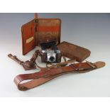 Two vintage tan leather belts, a tan leather and brass V shaped holster, a document case,