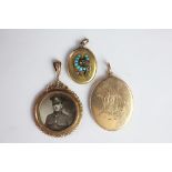 A yellow metal oval locket, monogrammed, stamped '15', weight 15.