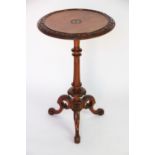 A Victorian carved walnut occasional table,