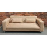 A modern tan suede three seater settee, possibly Italian, on turned white metal legs,