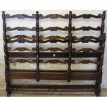 A stained beech ladderback three quarter bed retailed by Harrods,