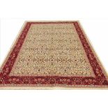 A Kashmir carpet, worked with an all over floral design against an ivory ground,