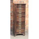 An early 20th century pine pillar chest, with locking bar and sixteen drawers, on bracket feet,