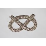 A diamond set Staffordshire knot brooch, the white metal brooch stamped '18ct',