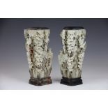 A pair of Chinese carved soapstone vases, each modelled with a tree,