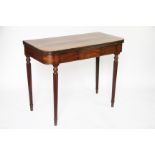 A Regency mahogany fold over card table, on turned and fluted legs (at fault),