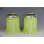 A pair of Edwardian green and white glass light shades, with moulded fluted detailing and N&G no.