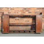 A George III oak plate rack, with two cupboard doors and five alcoves,