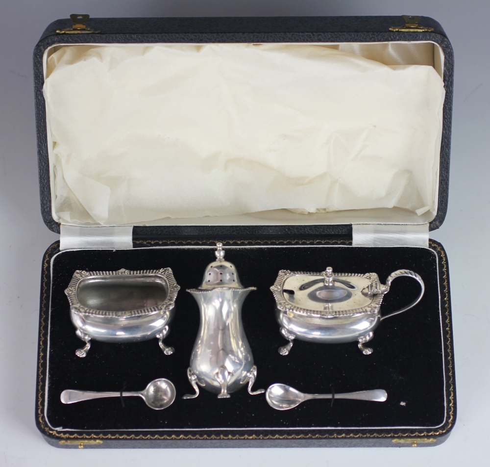 A cased silver condiment set, Chester 1957, comprising; mustard, pepperette and salt,