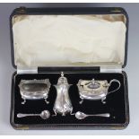 A cased silver condiment set, Chester 1957, comprising; mustard, pepperette and salt,