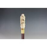 A gentleman's 'erotica' walking cane, the carved bone handle modelled with two lovers,