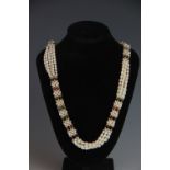 A five strand freshwater pearl and tourmaline bead necklace, with yellow metal clasp stamped '585',