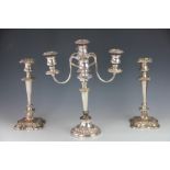 A pair of silver plated candlesticks, 31cm high, and a silver plated five light candelabrum,