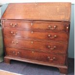 A George III oak bureau, with fall enclosing a fitted interior, above four graduated long drawers,