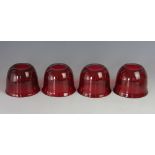A set of four Victorian ruby glass light shades,