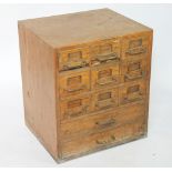 A vintage oak laboratory chest, of two short and nine short drawers, 61cm H x 53.5cm W x 45.