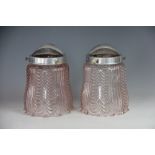 A pair of Edwardian tinted pink glass light shades, with moulded detailing and Veritas fittings,