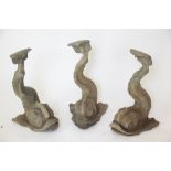 Three 19th century lead garden figures of dolphins,