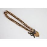 A yellow metal curb chain bracelet with heart shaped, padlock clasp, unmarked, weight 14.