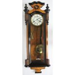 An ebonised walnut Vienna regulator, with enamelled Roman numeral dial with subsidiary seconds,