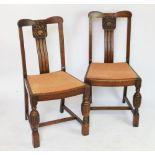 A set of four 1930's carved oak dining chairs, the backs decorated with fruit,