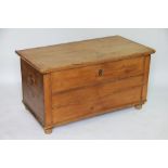 A pine coffer / blanket box, with iron loop handles, on turned feet,