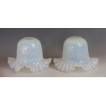 A near pair of Victorian opaline glass light shades, with moulded detailing and frilled rims,