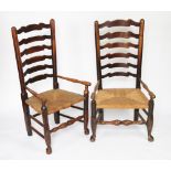 A near pair of 19th century beech and ash ladder back chairs, with turned arms, with rush seats,