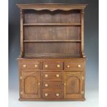 An apprentice piece small oak dresser, with pate rack, six drawers and two cupboard doors,