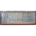 A 'Lloyds Bank Limited' gilt and frosted glass advertisement sign, in mahogany frame (as found),