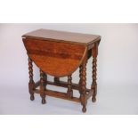 A 1920's oak gate leg table, on barley twist legs,