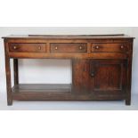 A George III oak dresser base, with three drawers above and cupboard and pot shelf, on square legs,