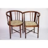 An Edwardian beech corner tub chair, on tapered legs,